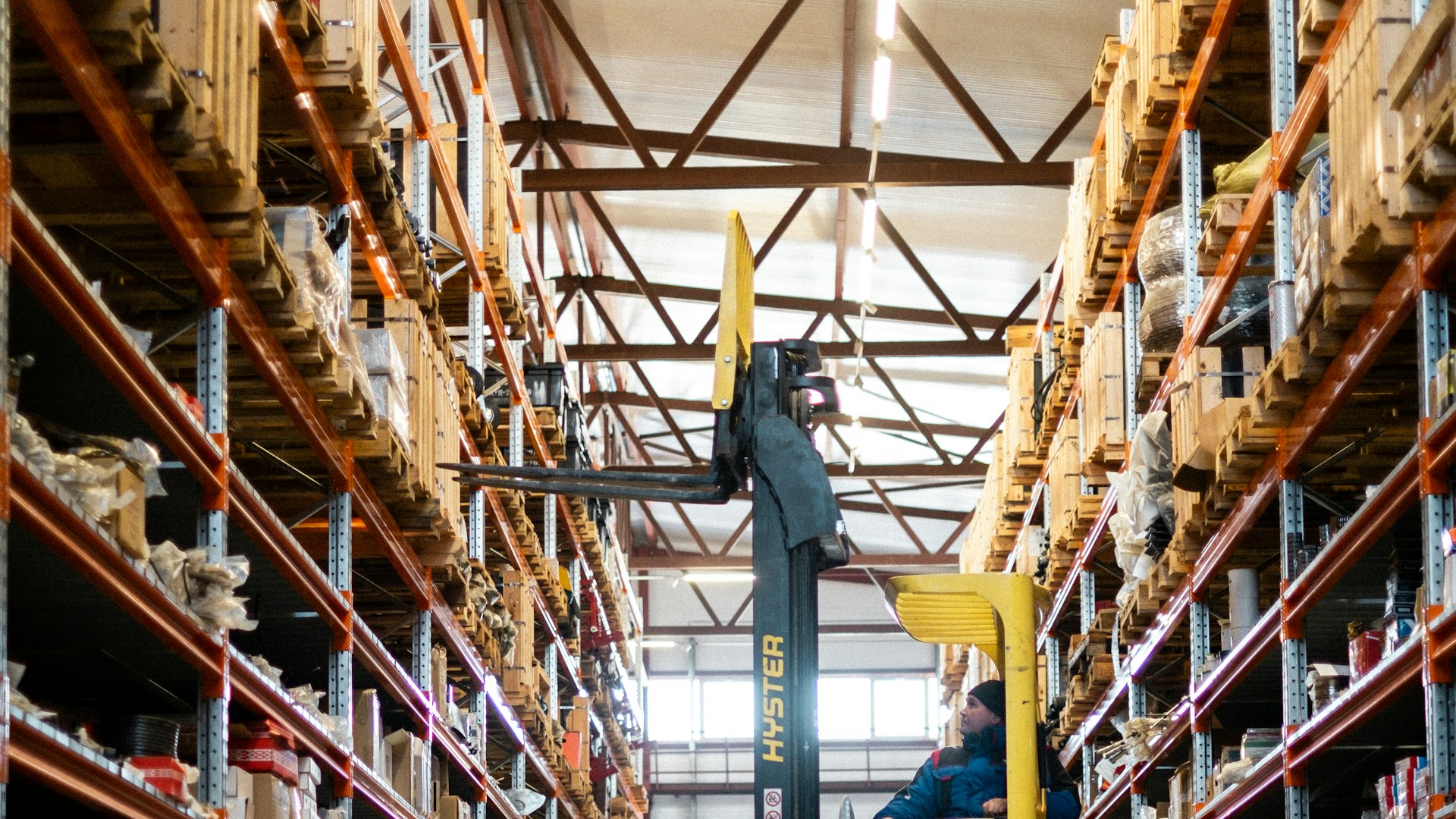 Warehouse operations worker managing inventory shelves