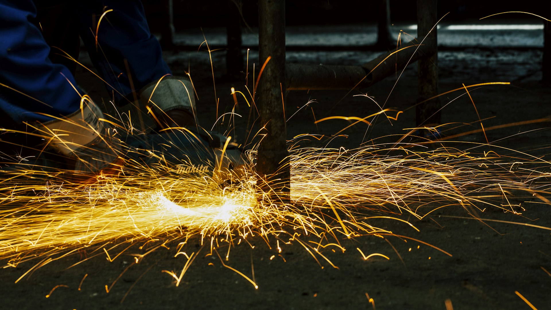 Sparks flying from metalwork on a manufacturing floor